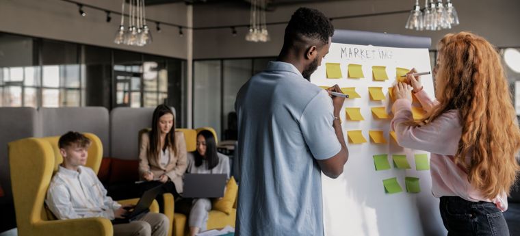 Team planning a workflow together on a whiteboard